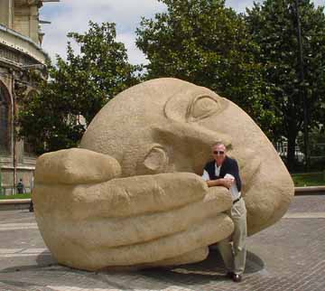 Rex with a carved figure in a Paris park