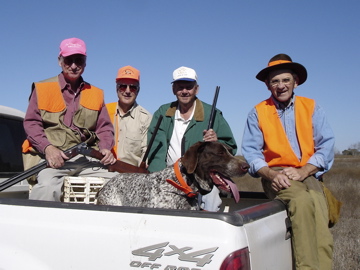 Hunters riding back with the dogs after the hunt